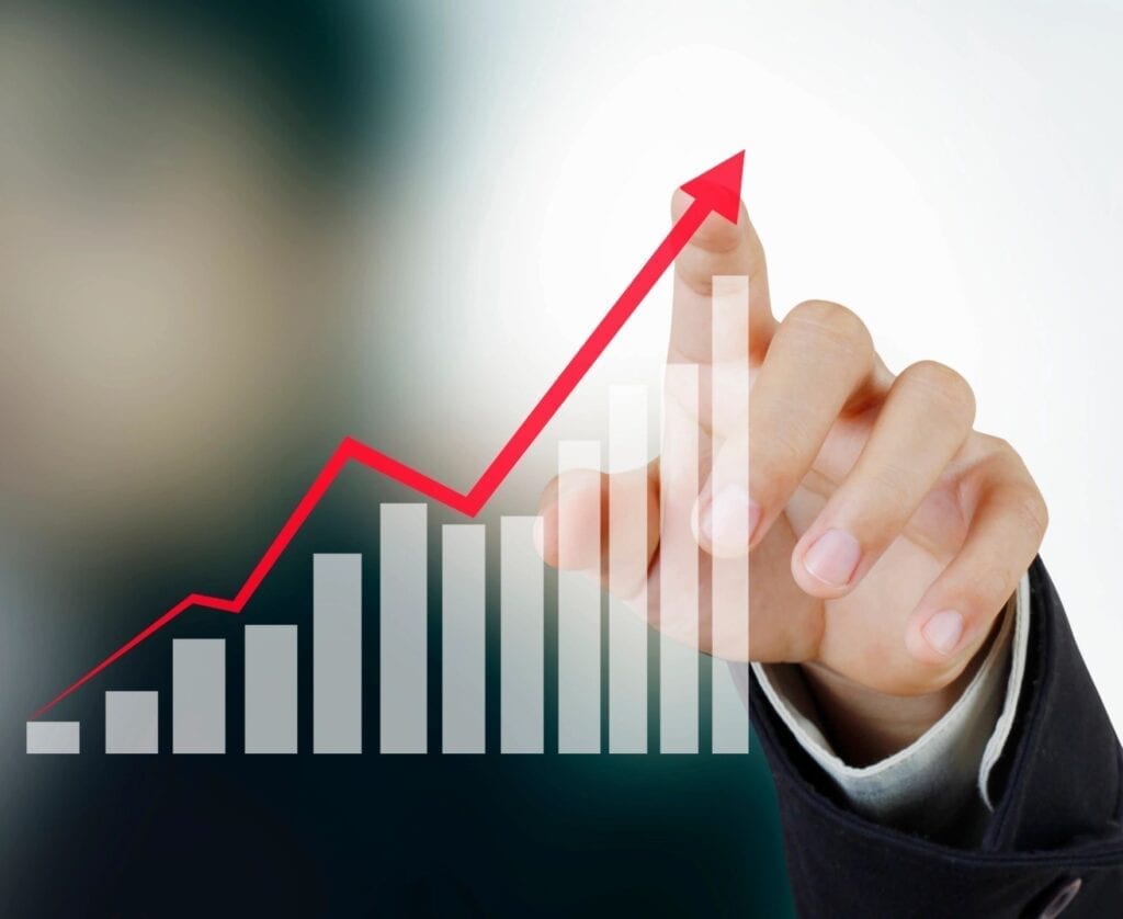 Man pointing at a graph with an upwards trajectory